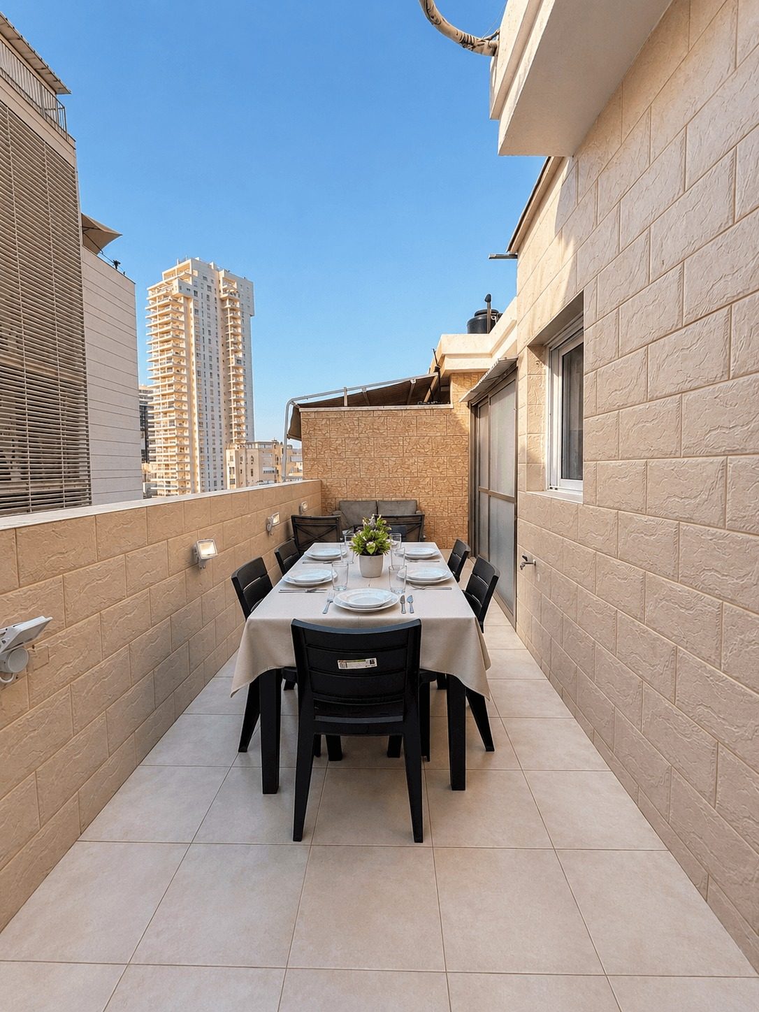 The Ussishkin Rooftop — Private rooftop terrace with outdoor dining table